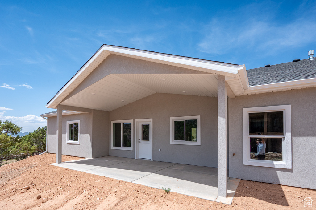 Back of house featuring a patio area and stucco siding