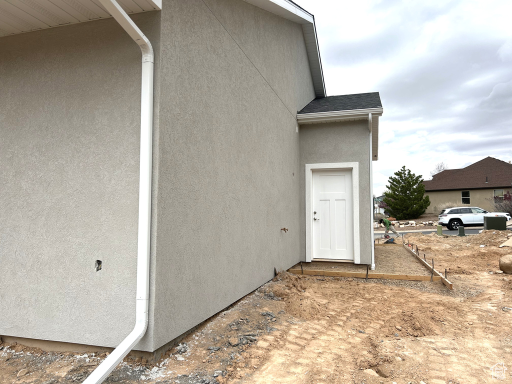 Doorway to property featuring stucco siding