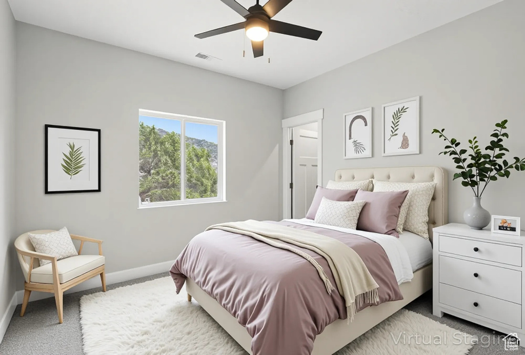 Bedroom with carpet, baseboards, and a ceiling fan