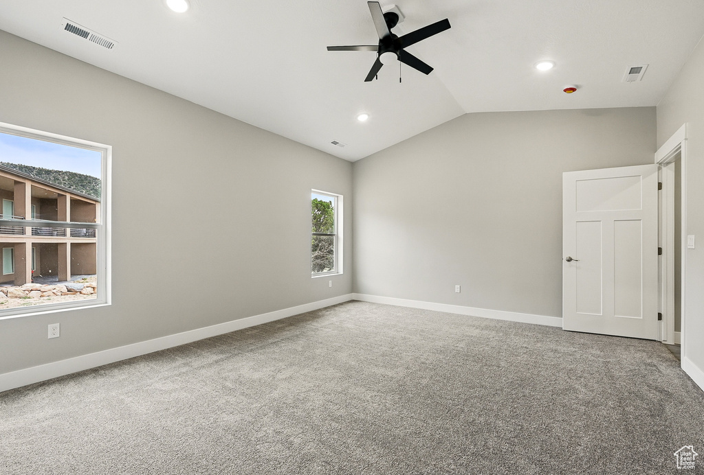 Unfurnished bedroom with recessed lighting, carpet flooring, lofted ceiling, baseboards, and ceiling fan