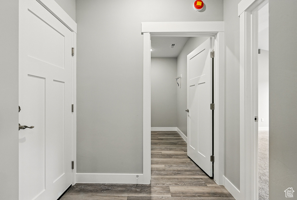 Hall with wood finished floors and baseboards