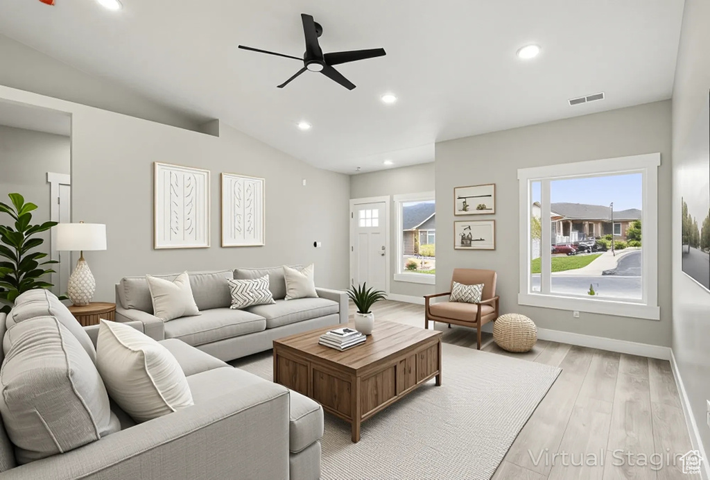 Living room featuring a ceiling fan, light wood-style floors, recessed lighting, baseboards, and vaulted ceiling