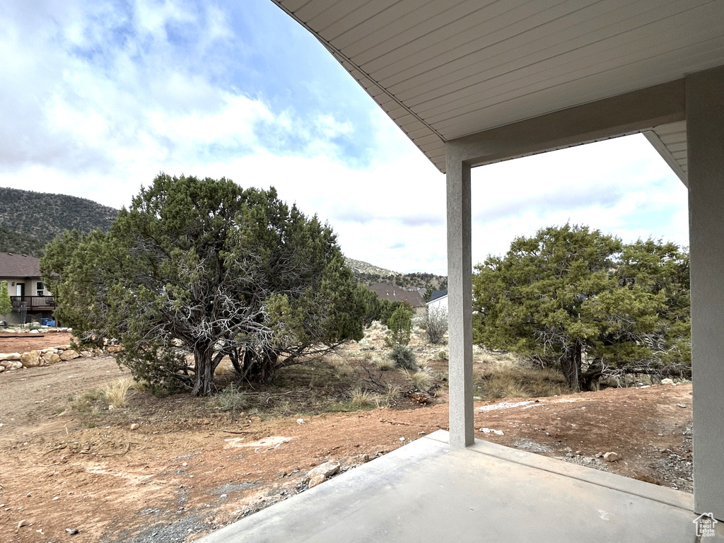 View of yard featuring a mountain view and a patio