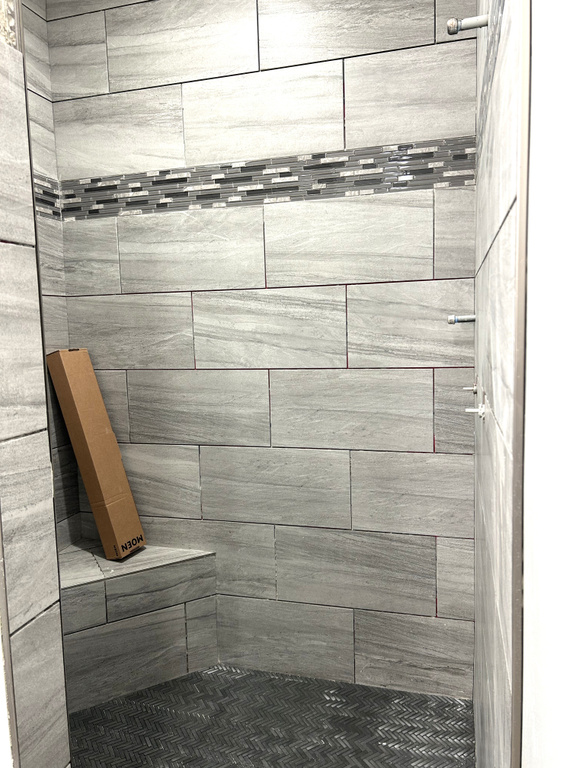 Full bathroom featuring tiled shower