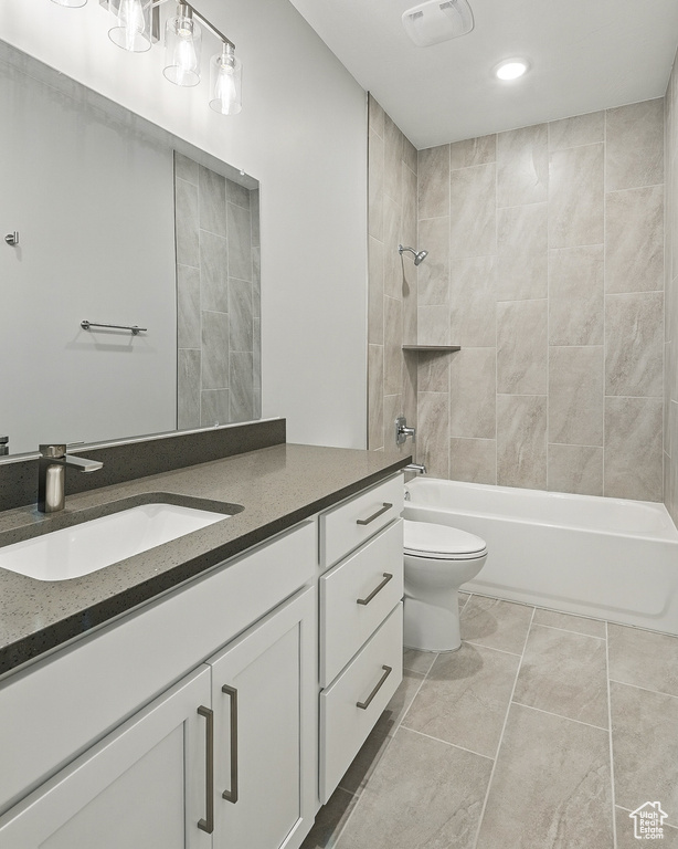 Bathroom featuring vanity, toilet, tub / shower combination, recessed lighting, and tile patterned floors