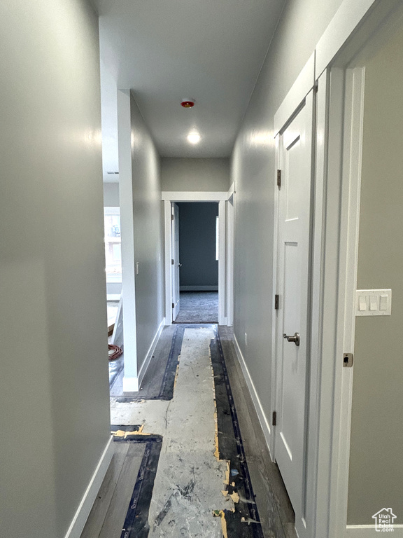 Corridor featuring baseboards