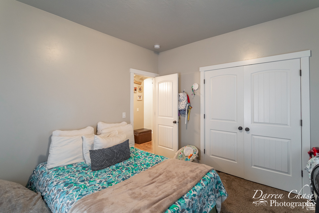 Bedroom with carpet and a closet