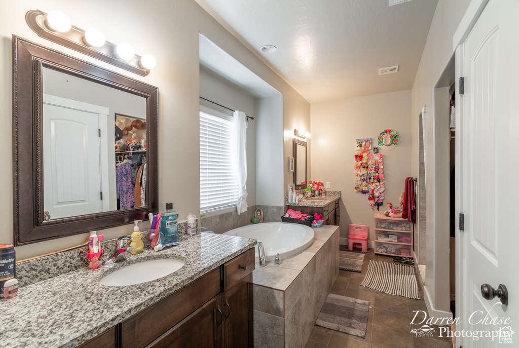 Full bath with a bath, visible vents, tile patterned flooring, and vanity