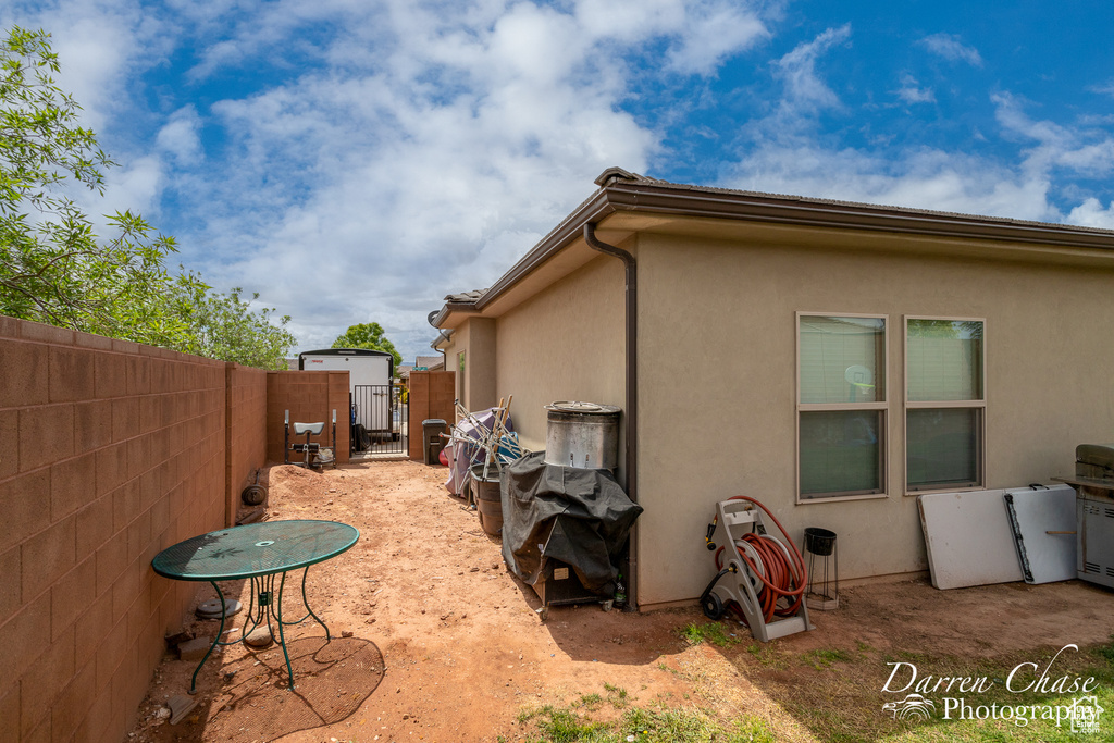 View of home's exterior with a gate, fence private yard, and stucco siding