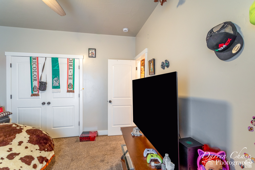 Carpeted bedroom featuring a ceiling fan