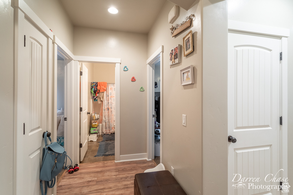 Hall with recessed lighting and light wood-type flooring