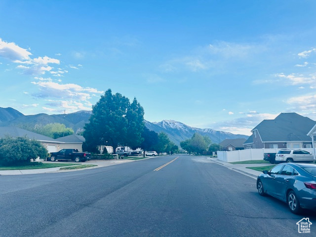 View of road featuring a mountain view, sidewalks, and curbs