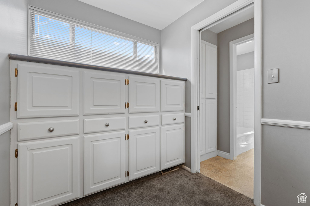 Interior space featuring baseboards and a tub