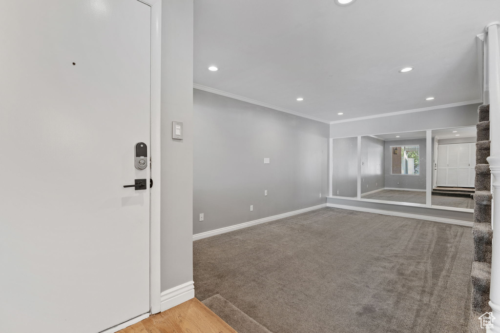 Interior space featuring carpet floors, baseboards, recessed lighting, and ornamental molding