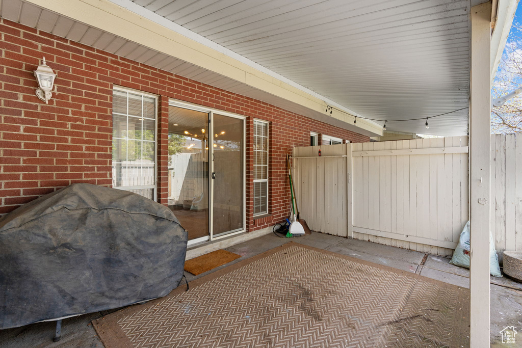 View of patio featuring grilling area and fence