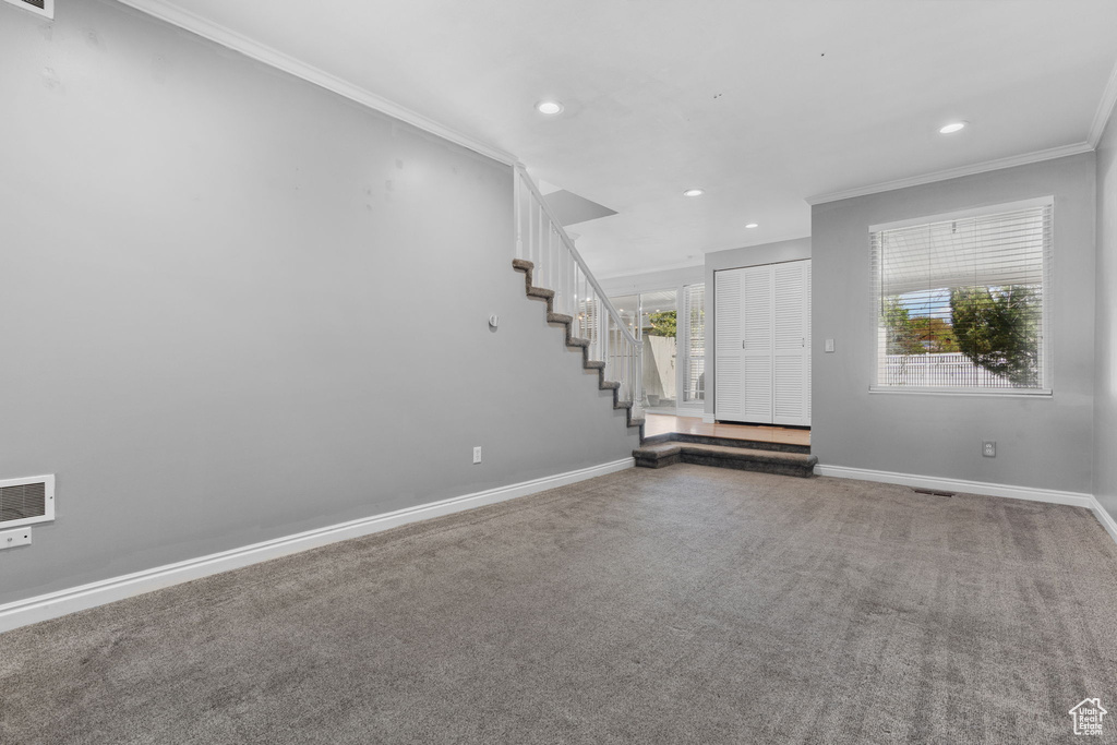 Foyer featuring recessed lighting, stairway, crown molding, baseboards, and carpet flooring