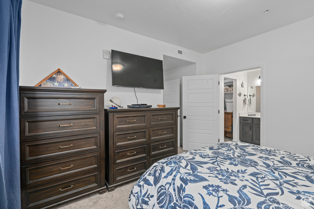 Carpeted bedroom with ensuite bath