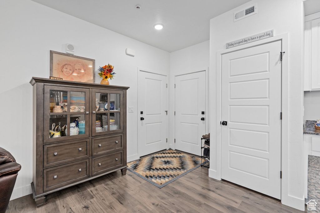 Entryway with recessed lighting, wood finished floors, and visible vents