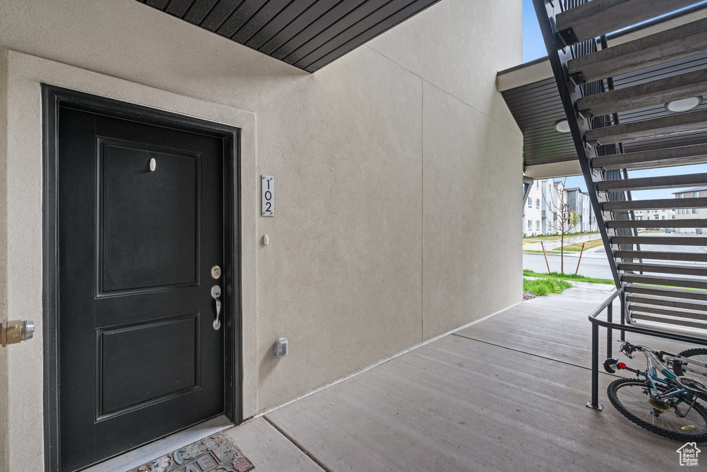 View of exterior entry with stucco siding