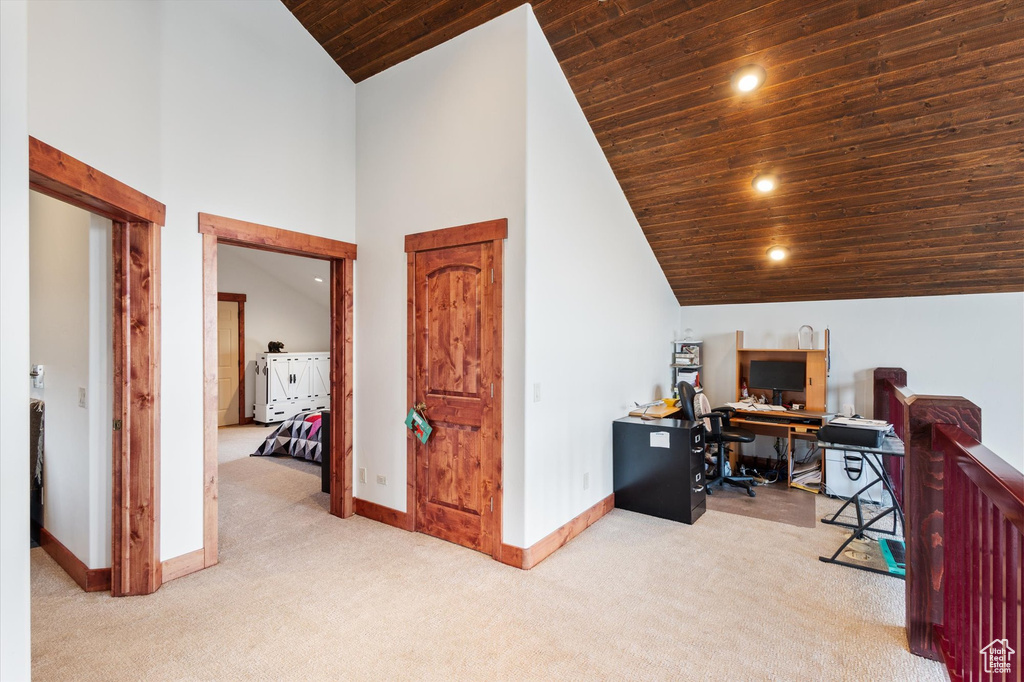 Carpeted office space featuring wooden ceiling, baseboards, high vaulted ceiling, and recessed lighting