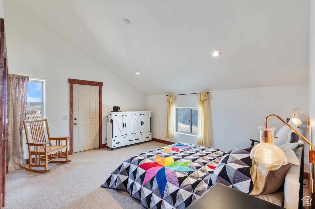 Bedroom featuring light colored carpet, vaulted ceiling, and recessed lighting