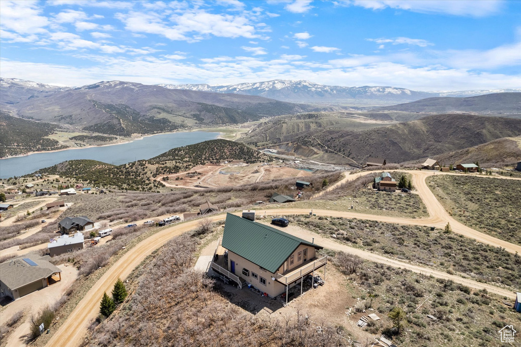 Drone / aerial view featuring a water and mountain view