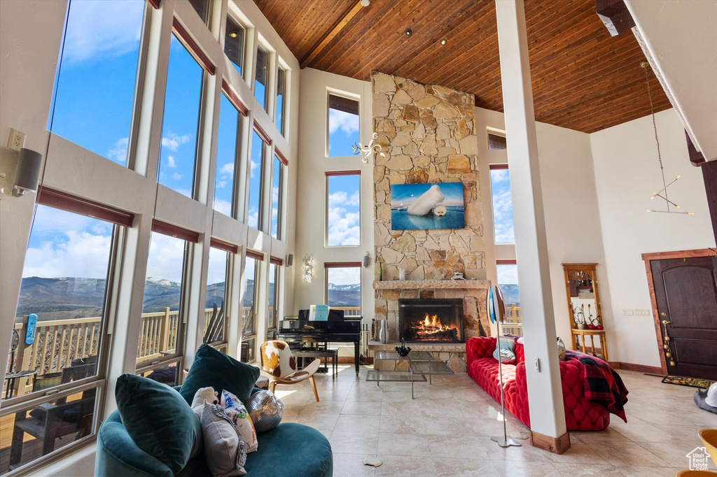 Living room featuring wooden ceiling, high vaulted ceiling, and a healthy amount of sunlight