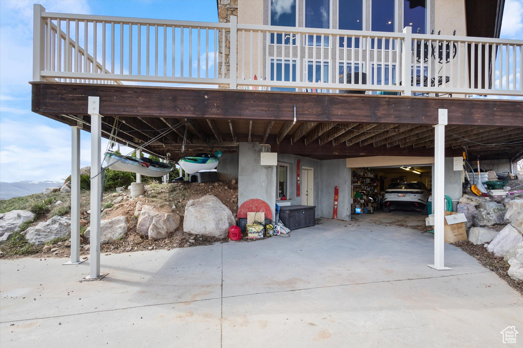 View of patio featuring a carport, a deck with mountain view, and concrete driveway