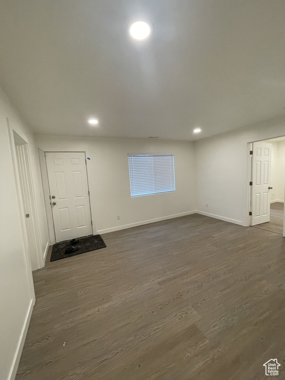 Unfurnished room with baseboards, dark wood-style flooring, and recessed lighting