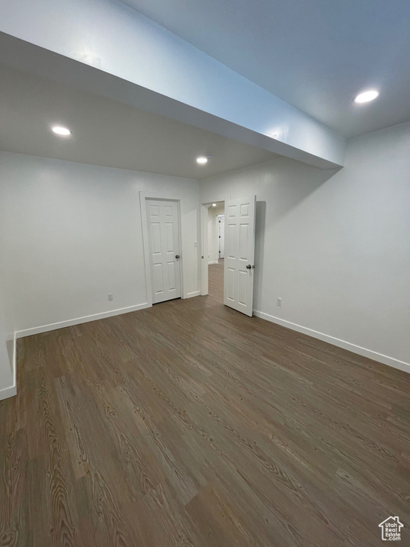 Finished basement featuring dark wood finished floors, baseboards, and recessed lighting