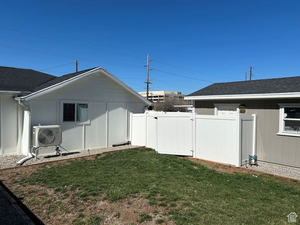 View of yard featuring ac unit and a gate