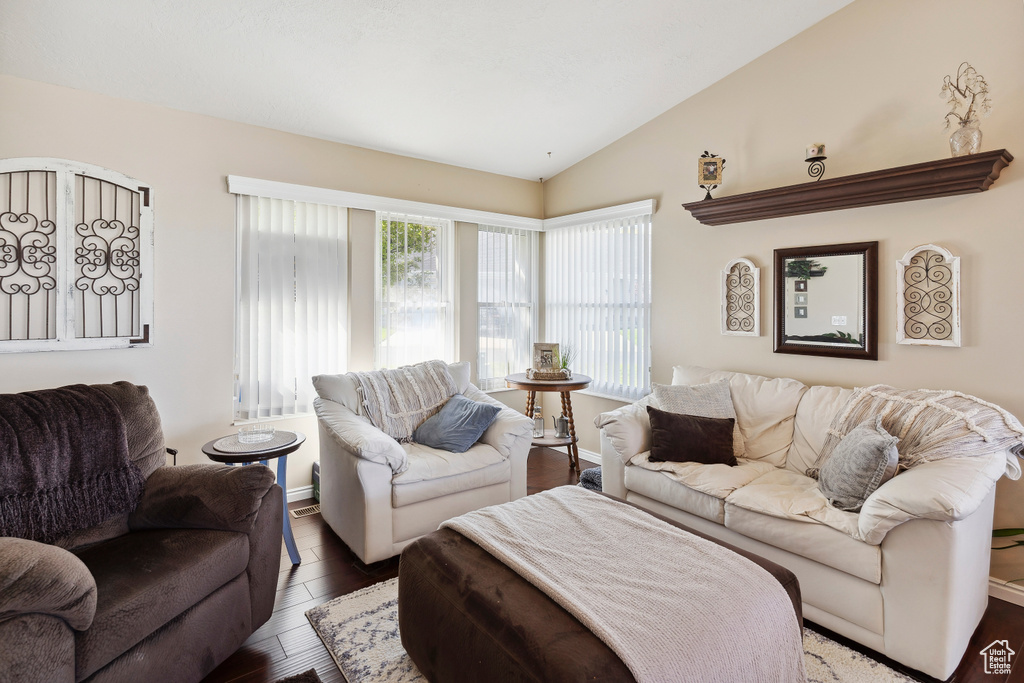 Living room with wood finished floors and lofted ceiling