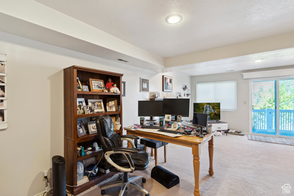 Carpeted home office with recessed lighting, a textured ceiling, and visible vents