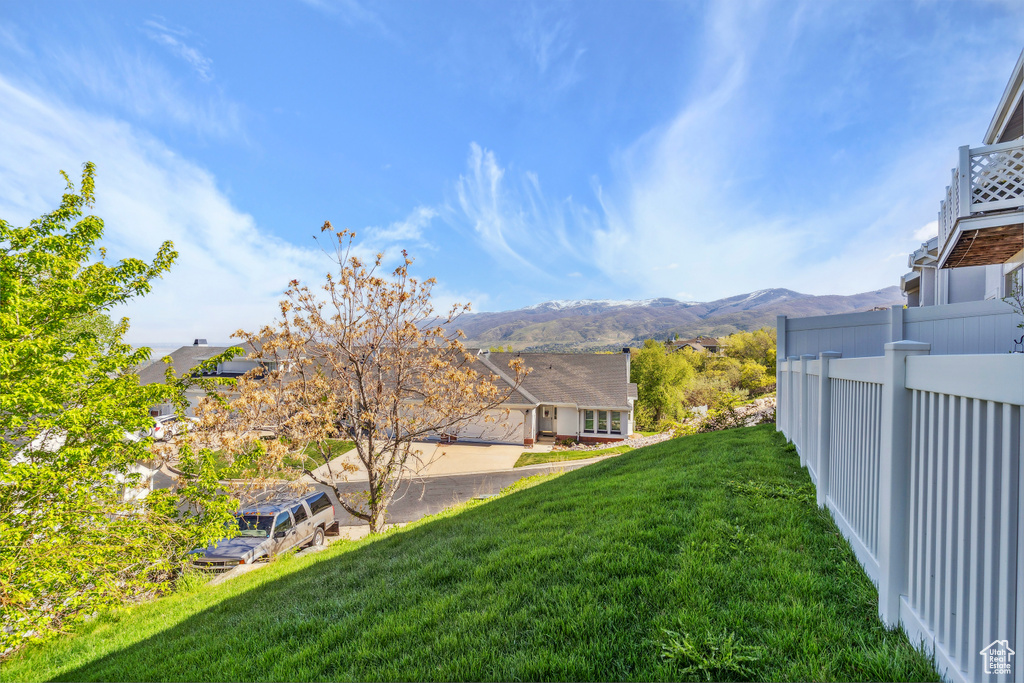 View of yard featuring fence and a mountain view