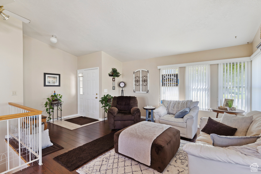 Living area with baseboards and wood-type flooring