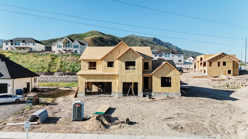 View of front of property with a mountain view and a residential view