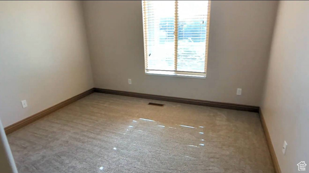Unfurnished room with baseboards and carpet flooring