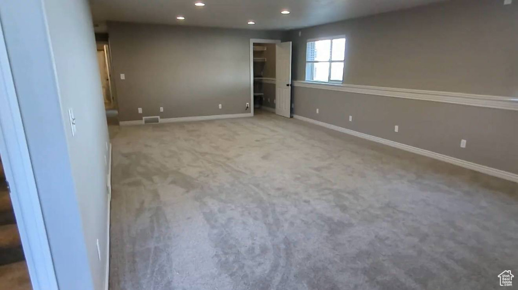 Carpeted empty room featuring recessed lighting and baseboards