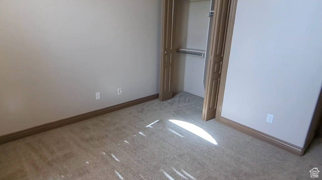 Unfurnished bedroom with carpet and baseboards