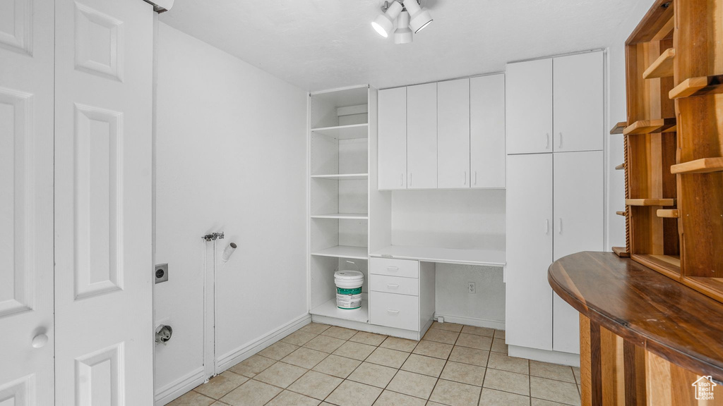 Unfurnished office featuring baseboards and light tile patterned floors