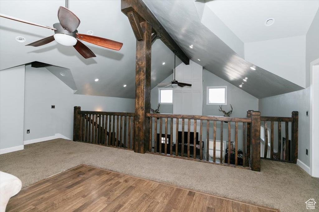 Bonus room featuring baseboards, ceiling fan, lofted ceiling with beams, and carpet floors