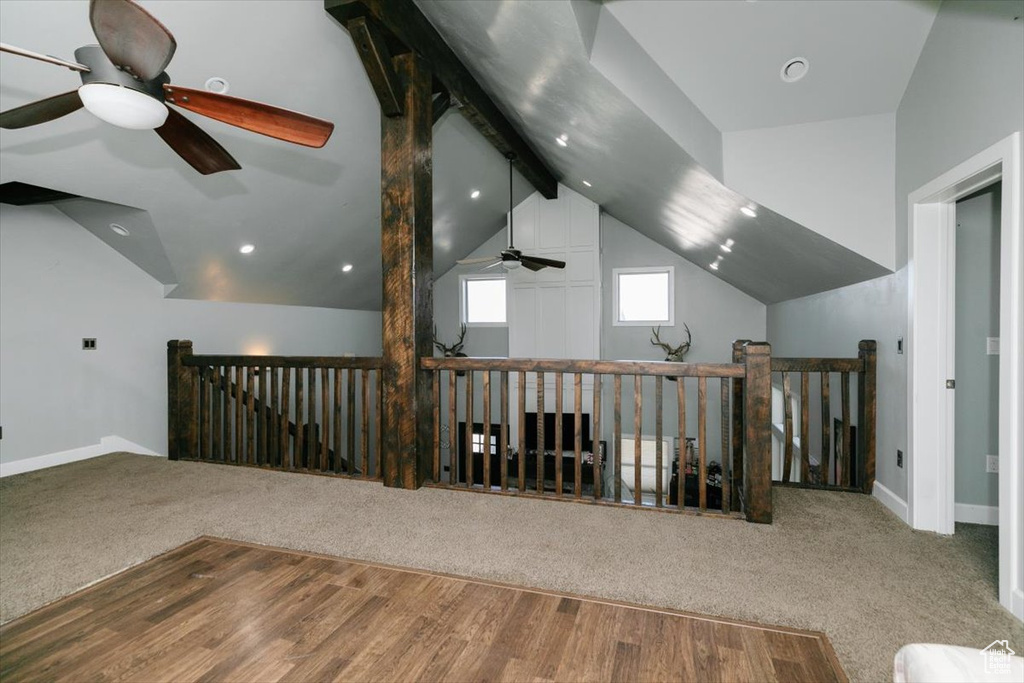Additional living space with recessed lighting, ceiling fan, vaulted ceiling with beams, and carpet