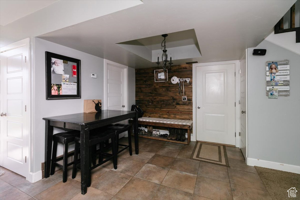 Dining area featuring baseboards and a raised ceiling