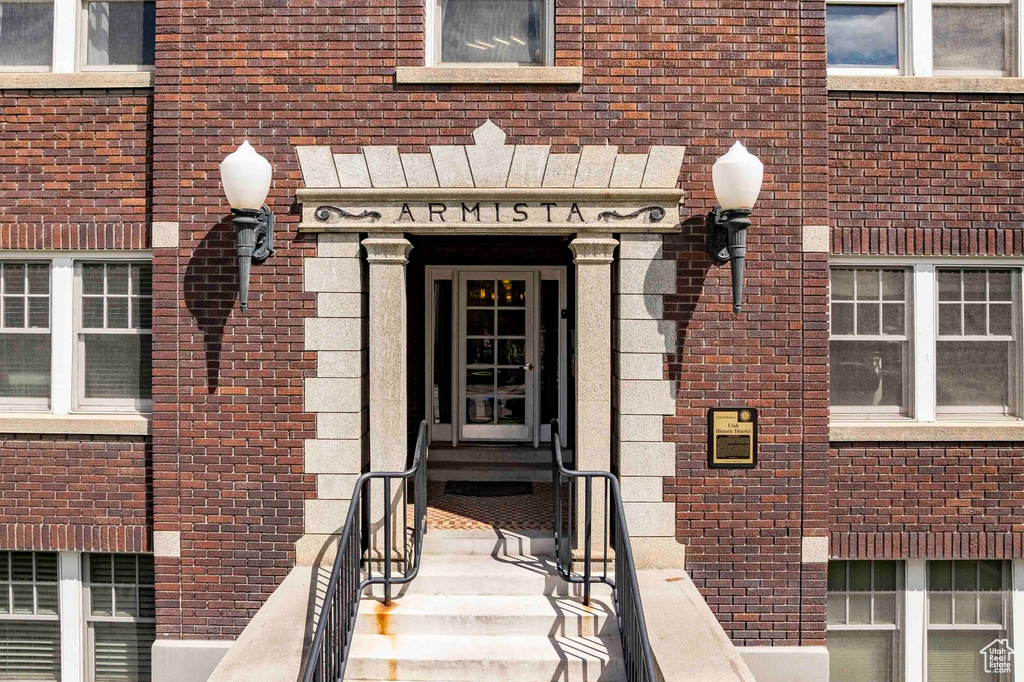 View of exterior entry featuring brick siding