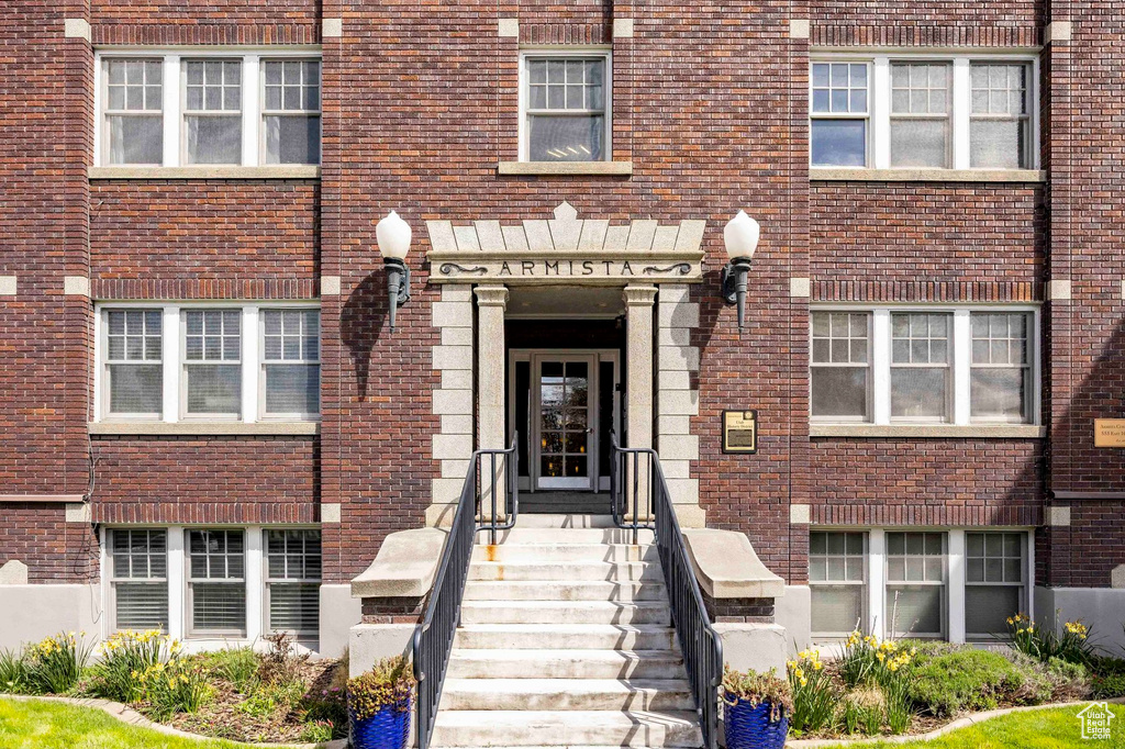 Property entrance featuring brick siding