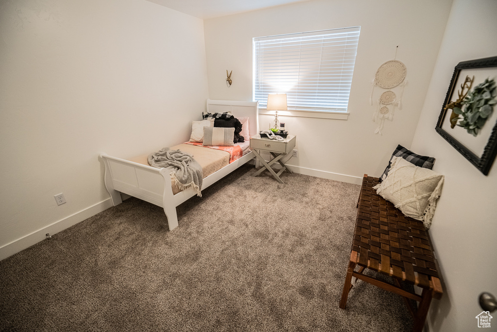 Bedroom with baseboards and carpet