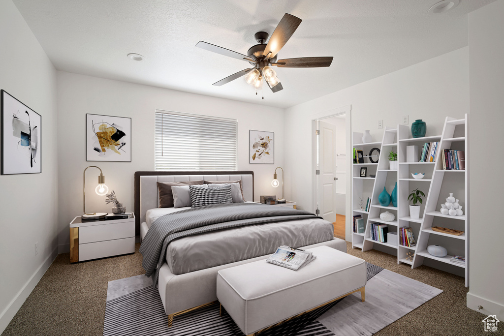 Carpeted bedroom featuring baseboards and ceiling fan
