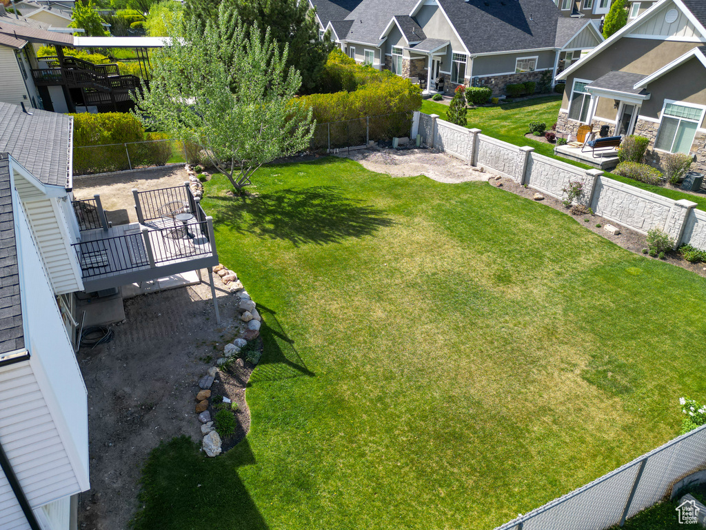 View of yard featuring a fenced backyard, a residential view, and a deck