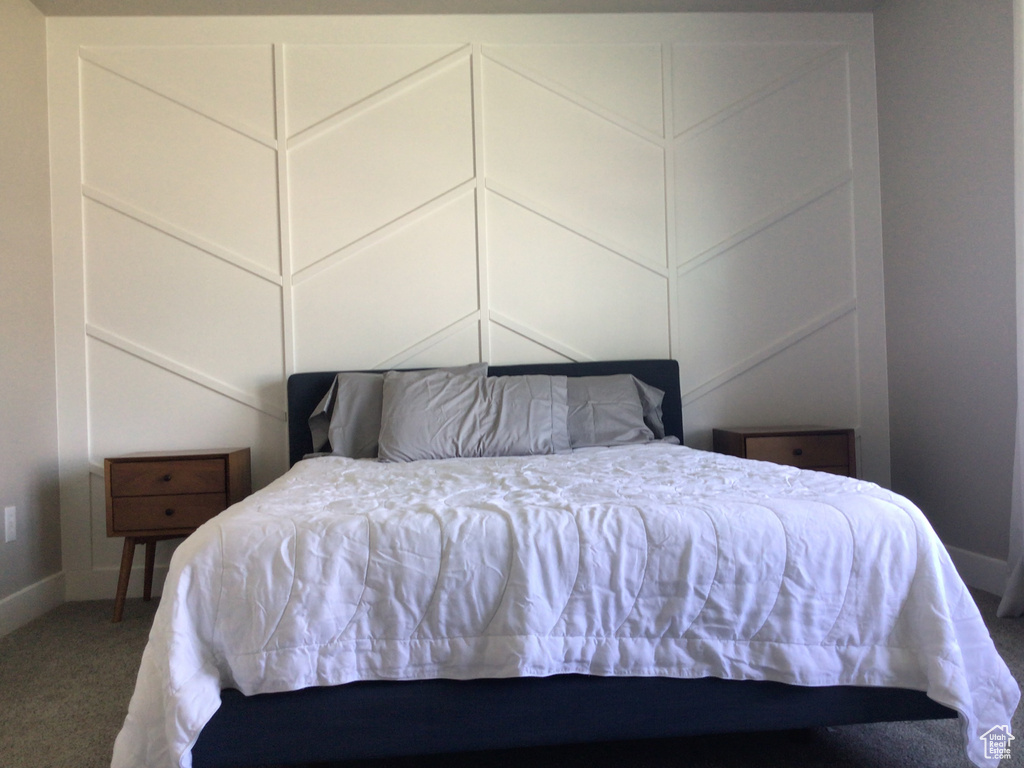Carpeted bedroom with baseboards