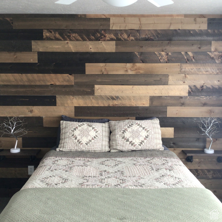 Bedroom featuring wooden walls